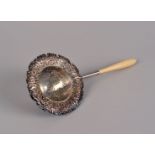 A Tiffany & Co. ivory handled sterling silver tea strainer, the beehive shape perforated bowl