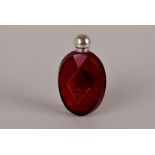A silver topped ruby glass scent bottle, of faceted form, and with rubbed marks to the lid 10cm H
