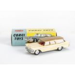 A Corgi Toys 219 Plymouth Sports Suburban Station Wagon, cream body with fawn roof, red interior,