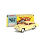 A Corgi Toys 218 Aston Martin DB4, primrose yellow body with vent, red interior, smooth hubs, in