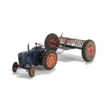 A Chad Valley Fordson Tractor and Rake, in blue, G, clockwork requires attention, rear hook