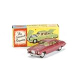 A Corgi Toys 238 Jaguar Mark X, metallic cerise body, lemon interior, spun hubs, two pieces of