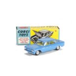 A Corgi Toys 229 Chevrolet Corvair, mid-blue body, yellow interior, spun hubs, in original box, E,