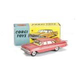 A Corgi Toys 220 Chevrolet Impala, pink body, lemon interior, spun hubs, in original box, E, box G