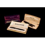 A pair of Sheaffer's Imperial Touchdown fountain pens, both boxed, one maroon and one black,