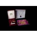 A collection of 9ct gold jewellery, including a wedding band, a garnet ring, and chains and