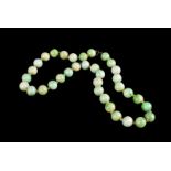 A green jade bead choker, each bead approx. 1cm dia.