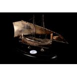 A white metal Dhow on stand, 21.5cm L