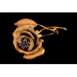 An 18ct gold rose blossom brooch, with sapphire cluster for the stamen 11.5g, presented in red