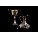 A collection of silver plated items, including a glass cruet set on stand, a twin handled trophy,