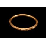 A 22ct gold ladies wedding band, having octagonal outer with alternate facet with engraving,