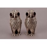 A pair of modern continental white metal novelty cruets, modelled as a pair of owls with red stone