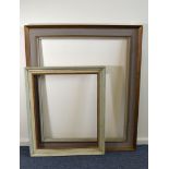 Three vintage picture frames, one larger example painted gold and grey, one in white, the other gilt