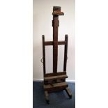 A vintage oak artist’s / restorer’s easel, the double sided stand with screw mechanism lower lifting