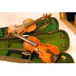 Violins, a pair (full size) the first in hard case, two strings, no markings, wear on neck