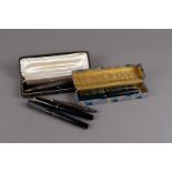Five vintage fountain pens and two pencils, including a silver fountain pen and pencil set, boxed, a