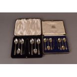 Two George V cased sets of teaspoons and tongs, each with six spoons and a pair of sugar nips,