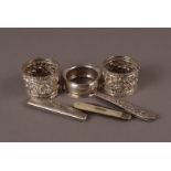 A pair of Victorian silver embossed napkin rings, together with another silver napkin ring, an