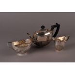 An associated Edward VII and George V silver bachelors three piece tea set, all with fluted