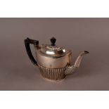 A late Victorian silver teapot, having fluted lower section, applied black handle and finial, London
