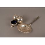 A Geroge V silver tea strainer, the circular dish, pierced design surrounded by floral swags, on a