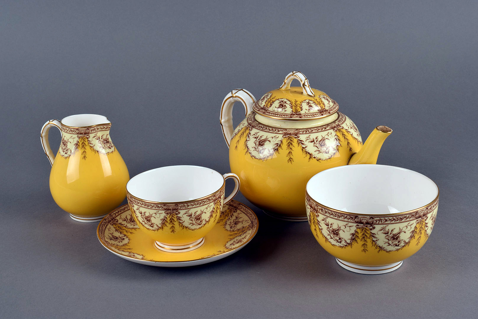 A Royal Worcester yellow part tea set, comprising teapot, five cups and saucers, sugar bowl and a