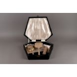 A cased modern four piece silver dressing table set from Walker & Hall, Sheffield in black fitted