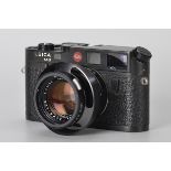 A Leica M6 Rangefinder Camera, black, serial no. 1667838, with Leitz Summilux f/1.4 50mm lens,