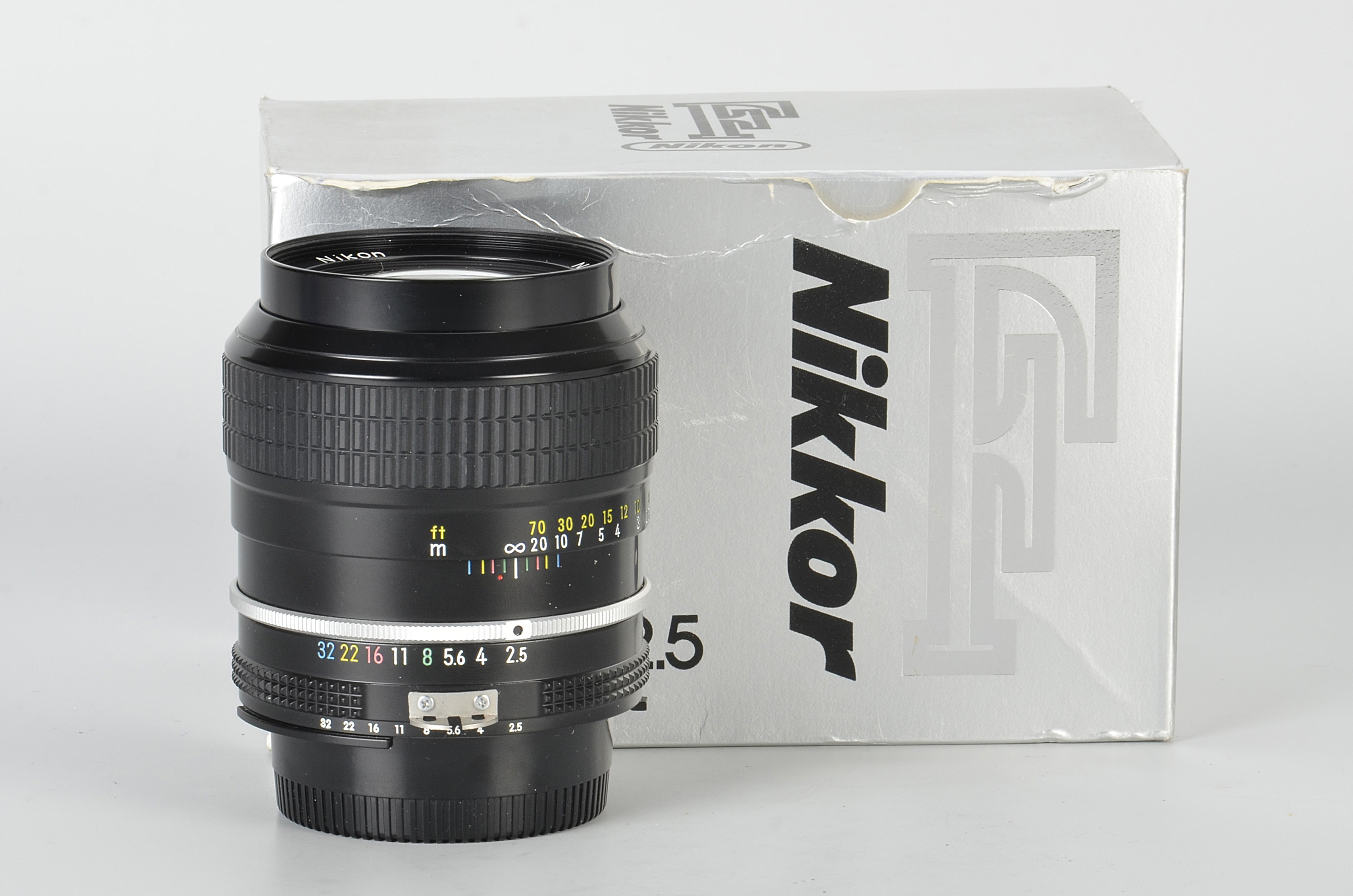 A Nikon AI f/2.5 105mm Lens, black, serial no. 674645, body, E, elements, VG-E, in maker’s box