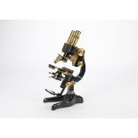 An Ernst Leitz lacquered brass and black-enamelled Binocular Microscope, with Y-shaped foot,