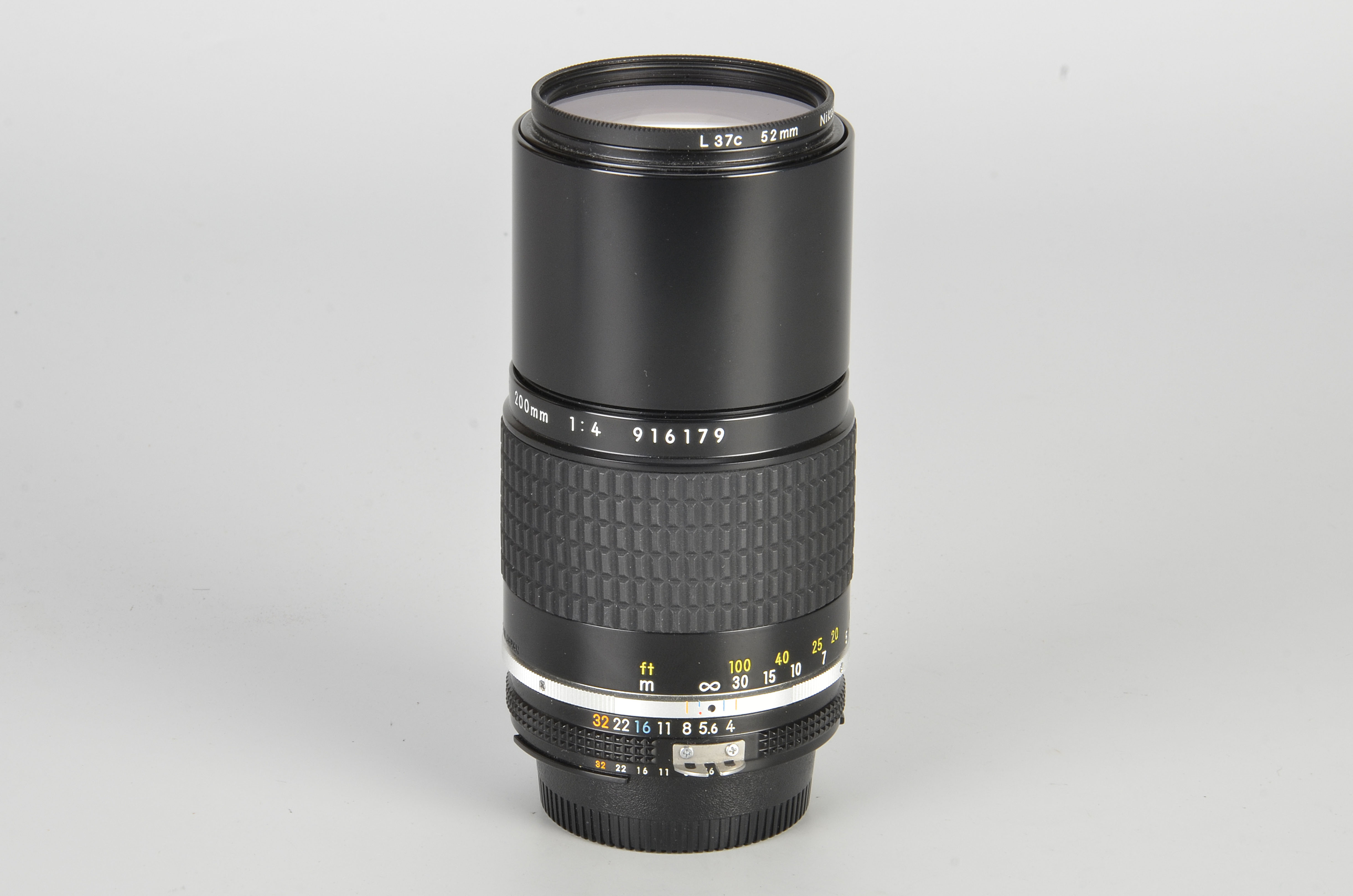 A Nikon AIS f/4 200mm Lens, black, serial no. 916179, body, E, elements, VG-E, with maker’s caps