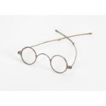 A pair of early 19th Century silver metal spectacles of small size, circular lenses, flat bridge,