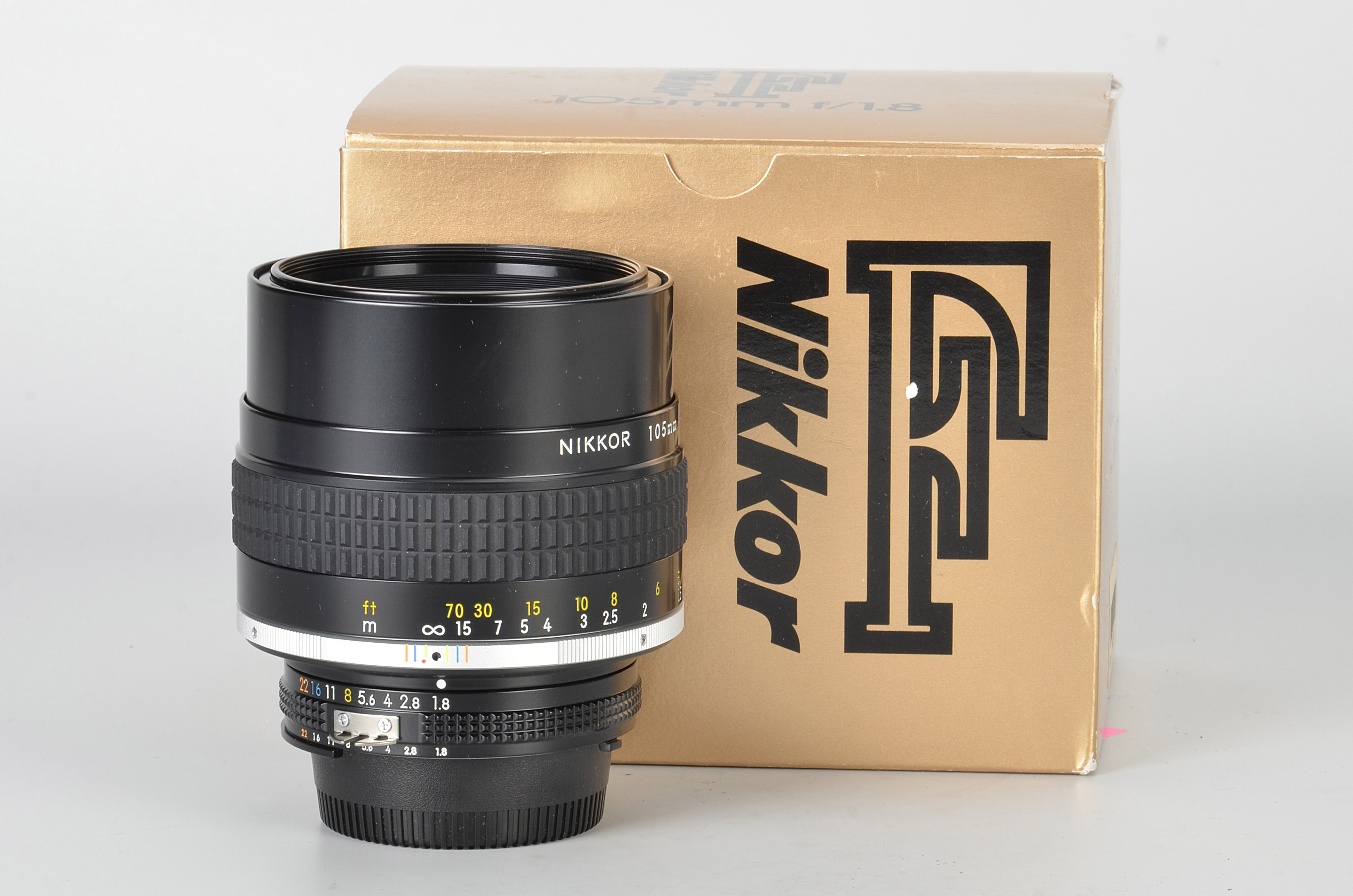 A Nikon AIS f/1.8 105mm Lens, black, serial no. 220358, body, E, elements, VG-E, in maker’s box