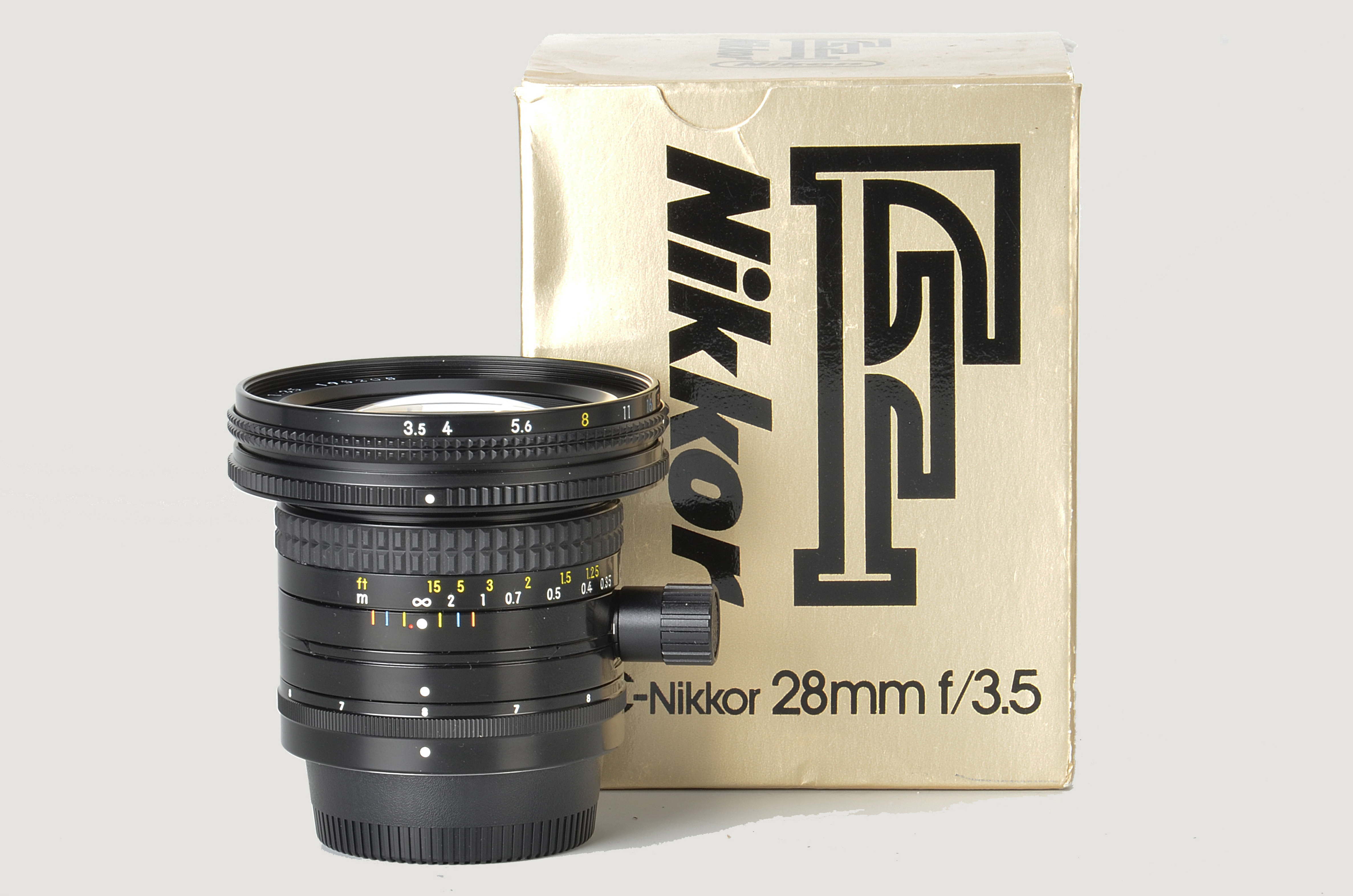 A Nikon PC-Nikkor f/3.5 28mm Lens, black, serial no. 195205, body, E, elements, E, in maker’s case