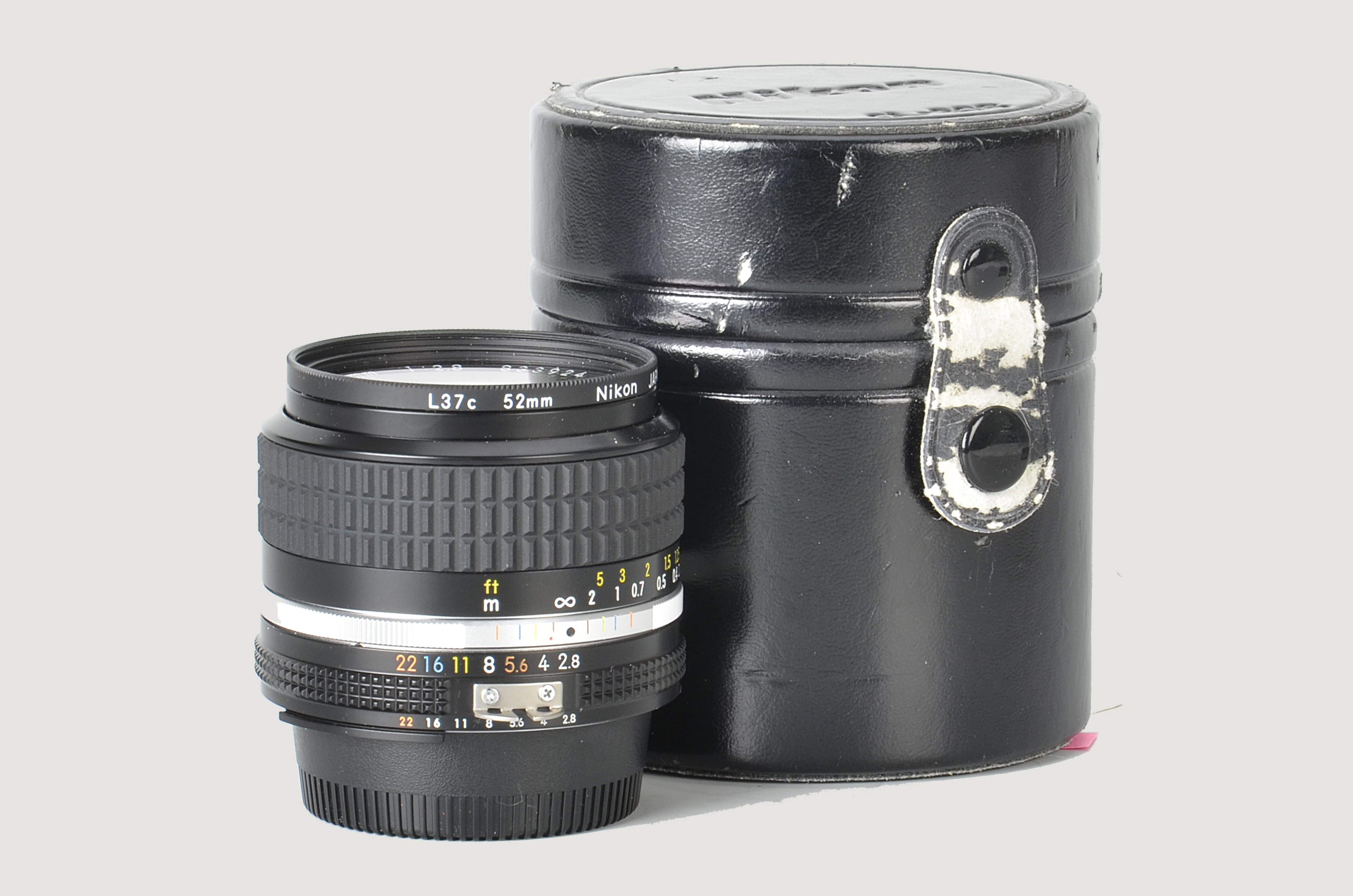 A Nikon AIS f/2.8 24mm Lens, black, serial no. 833924, body, E, elements, VG-E, in maker’s case