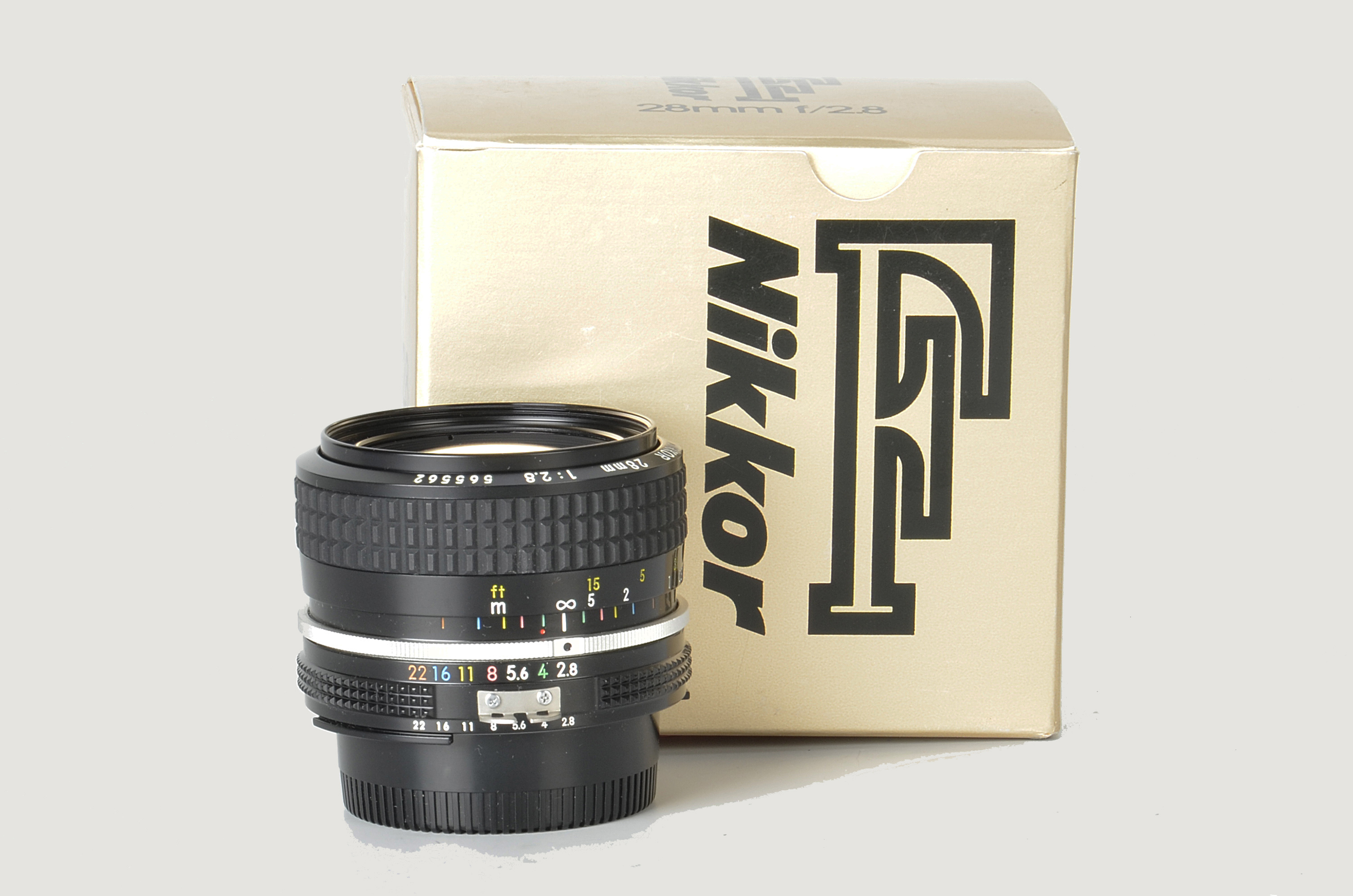 A Nikon AI f/2.8 28mm Lens, black, serial no. 565562, body, E, elements, VG, in maker’s box