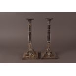 A pair of George III silver candlesticks by W.C, London 1772, possibly William Cripps, having square