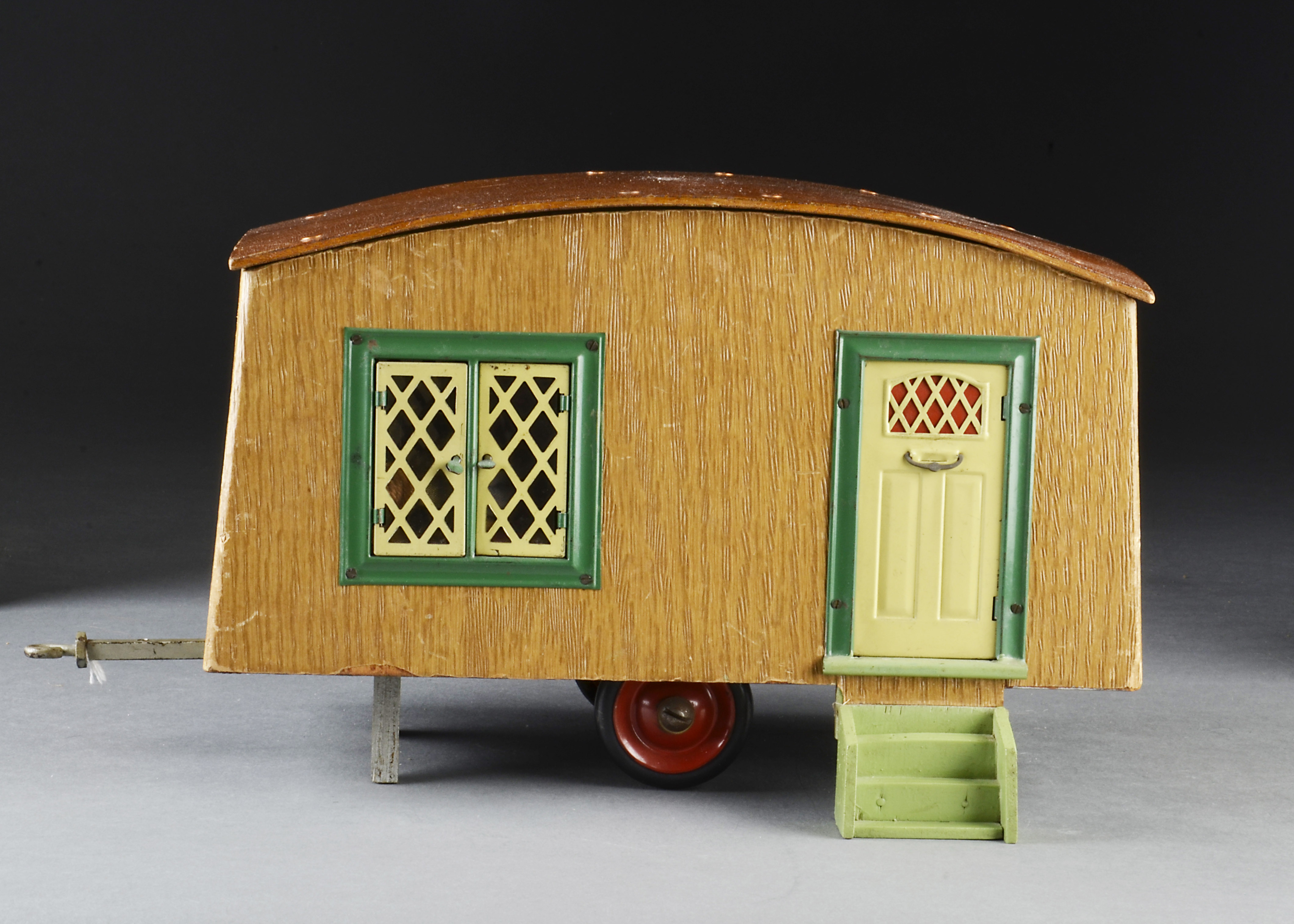 A rare Tri-ang caravan 1950s, wooden two-wheeled trailer covered in wood effect paper, tinplate