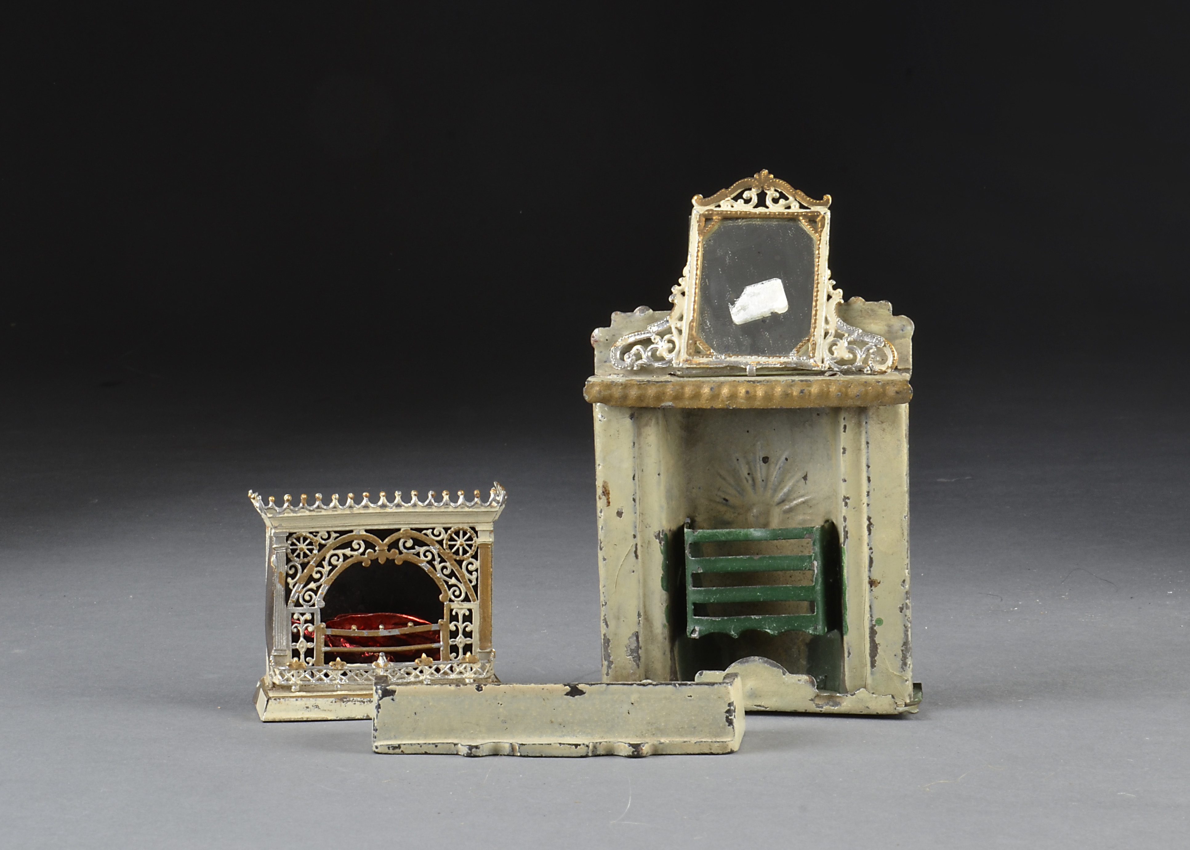 An Evans & Cartwright tinplate fireplace, cream and gold with green grate - 43?4in. (12cm.) high;