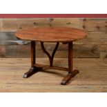 VICTORIAN OAK CRICKET TABLE With a circular tilt-top, raised on trestle legs. 27 1/2 x 41 3/4 in.