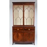 GEORGE III MAHOGANY SECRETARY BOOKCASE With an overhanging dentil molded cornice above a pair of