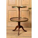 VICTORIAN BRASS-MOUNTED PADOUK TWO-TIER DUMBWAITER The two circular shelves within brass borders,