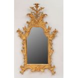 FINE ITALIAN ROCOCO GILTWOOD MIRROR With and arched mirror plate surmounted by a mask issuing a