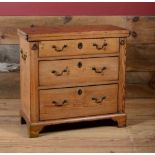 GEORGE III STYLE PINE BACHELOR'S CHEST, 19TH CENTURY With a hinged top above three graduating