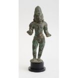 SOUTH INDIAN BRONZE FIGURE OF SKANDA, CHOLA DYNASTY Standing in contrapposto with raised forearms,