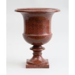 FINE SWEDISH NEOCLASSICAL CARVED RED PORPHYRY URN Of campani form with everted rim, on square