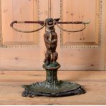 VICTORIAN PAINTED CAST-IRON UMBRELLA STAND In the form of a dog supporting a whip. 23 x 24 1/2 x