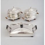 PAIR OF GEORGE III CRESTED SHEFFIELD PLATE SAUCE TUREENS ON WARMING STANDS Each oval bowl with