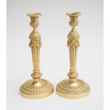 PAIR OF LOUIS XVI ORMOLU CANDLESTICKS Each with an urn-form nozzle above the stop-fluted stem fitted