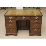 GEORGE III MAHOGANY KNEEHOLE DESK With a gilt-tooled leather-lined writing surface, above three